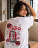 Woman wearing a white t-shirt with a graphic design of Diet Coke can and eyes.