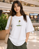 Woman wearing a white t-shirt with a graphic design in a mall