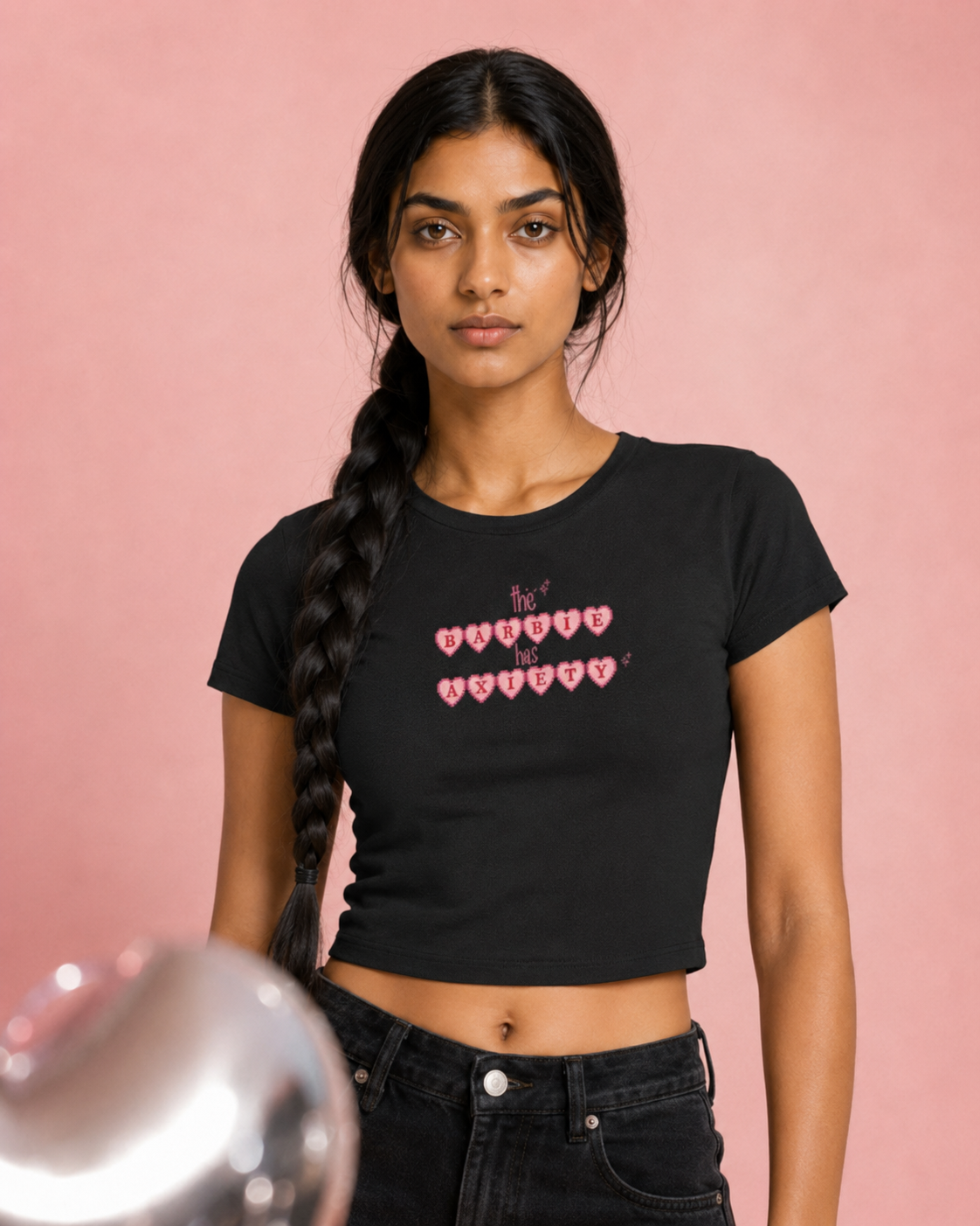 Woman wearing a black t-shirt with pink text on a pink background