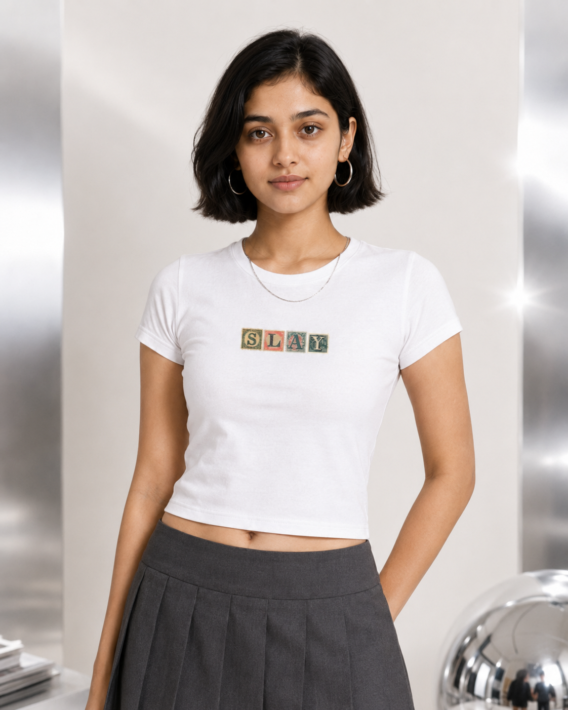 Person wearing a white t-shirt with 'SLAY' print against a neutral background