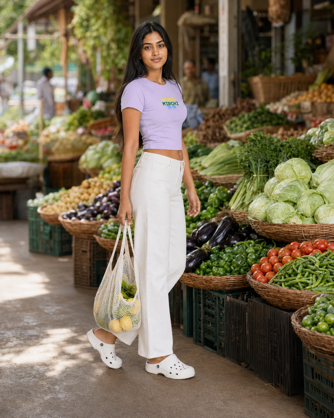 Woman holding a reusable bag with groceries at an outdoor market.
