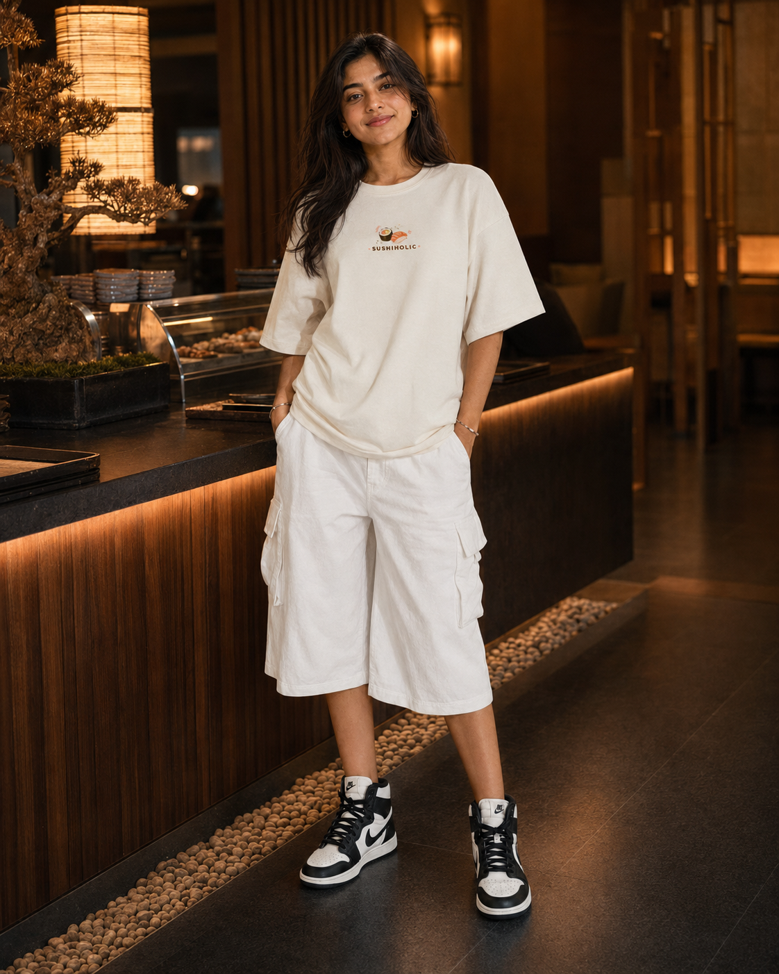Woman in a white outfit standing in a modern indoor setting